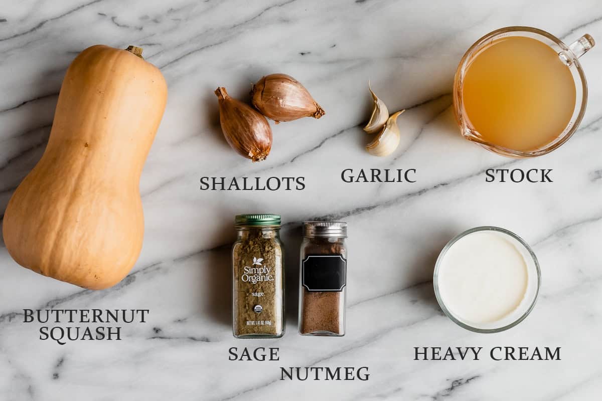 Ingredients needed to make butternut squash sauce on a marble background with text overlay.