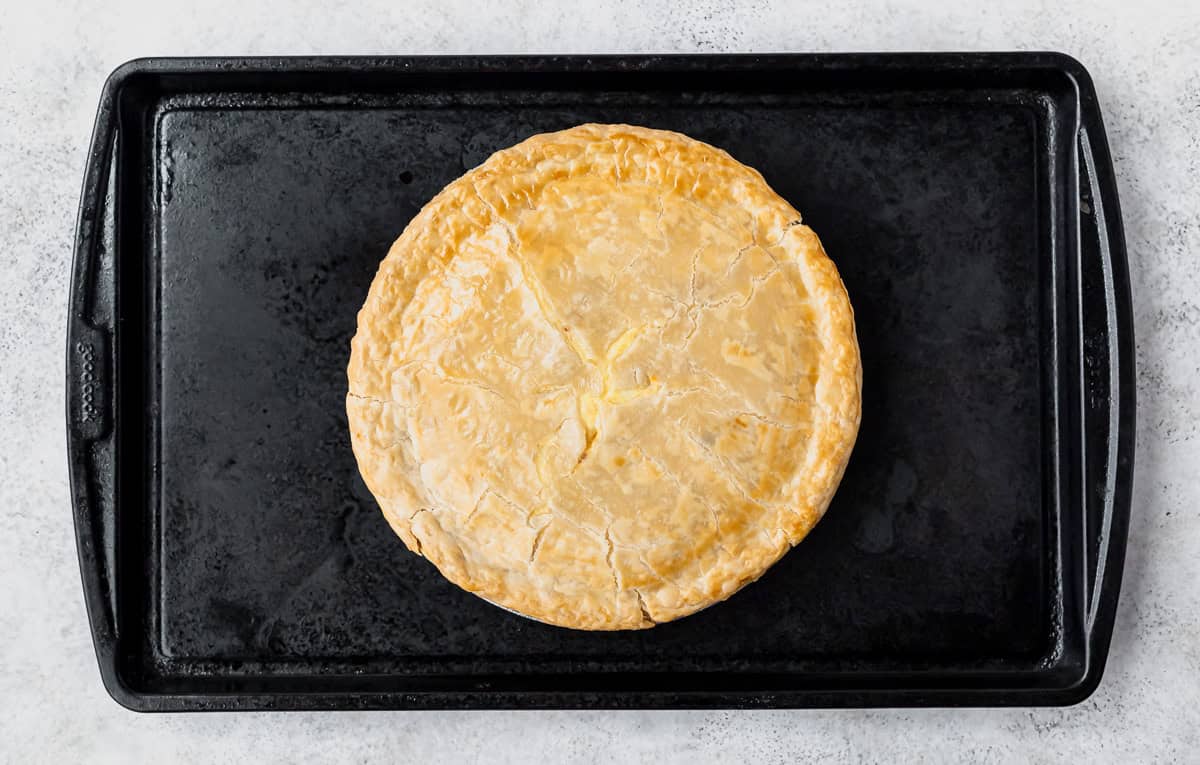 A baked Italian Easter Pie on a baking sheet.