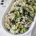 Broccoli crunch salad on a white serving plate.