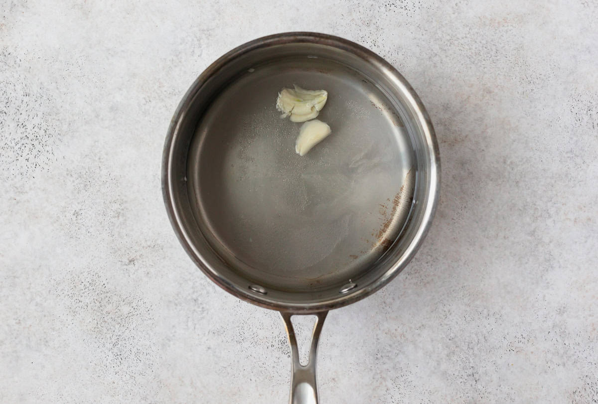 Vinegar, garlic and sugar in a silver pot.
