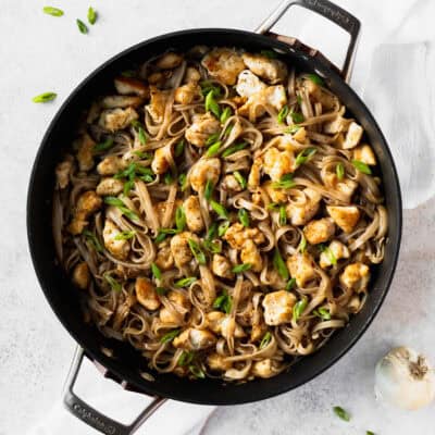 Overhead view of a skillet filled with honey garlic chicken noodles.