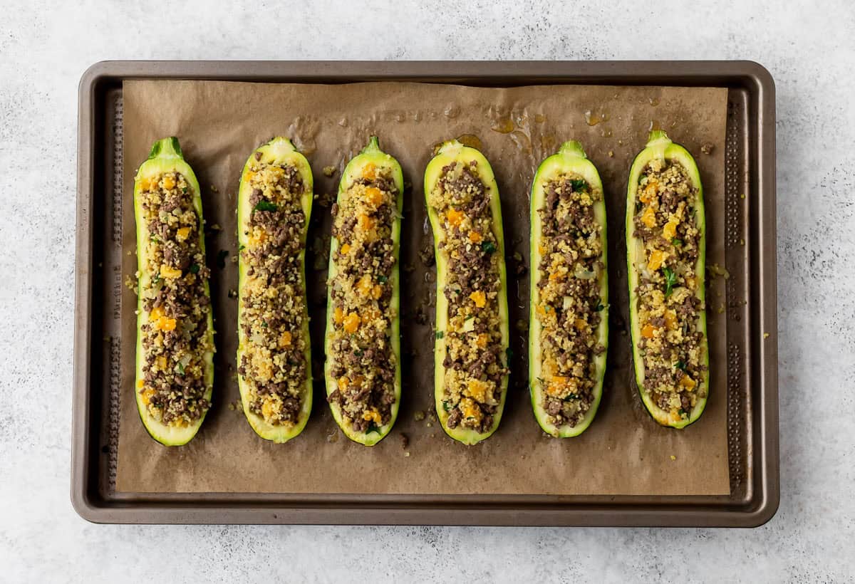Zucchini halves filled with ground beef, couscous and apricot mixture.